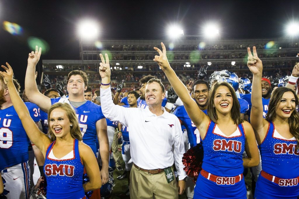 SMU head coach Chad Morris stands for the school song after the Mustangs 31-13 victory over North Texas an NCAA football game at Ford Stadium on Saturday, Sept. 12, 2015, in Dallas. The win is Morris' first as a collegiate head coach. (Smiley N. Pool/The Dallas Morning News)