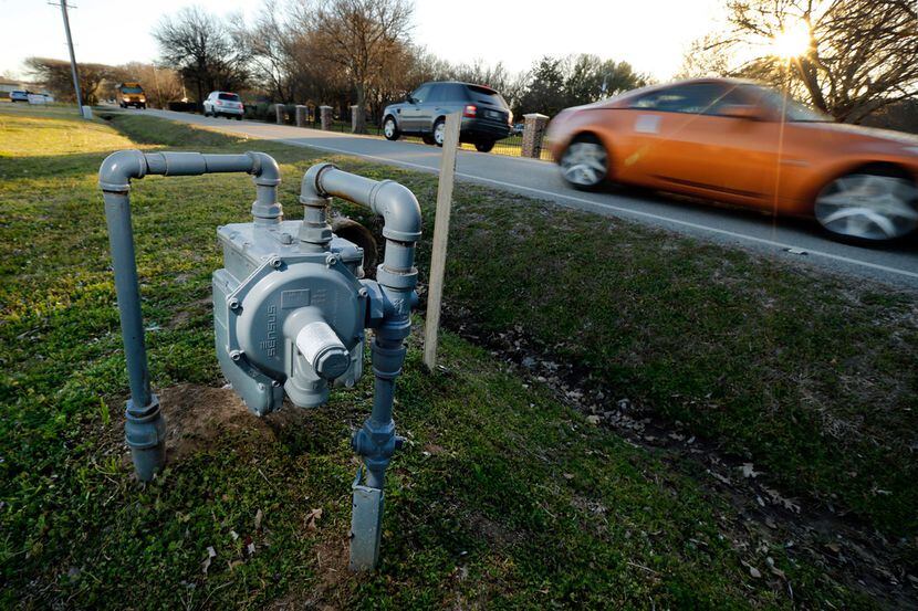 Vehicles pass a gas meter at 223 S Pearson Lane in Keller, Texas, Monday, February 25, 2019....