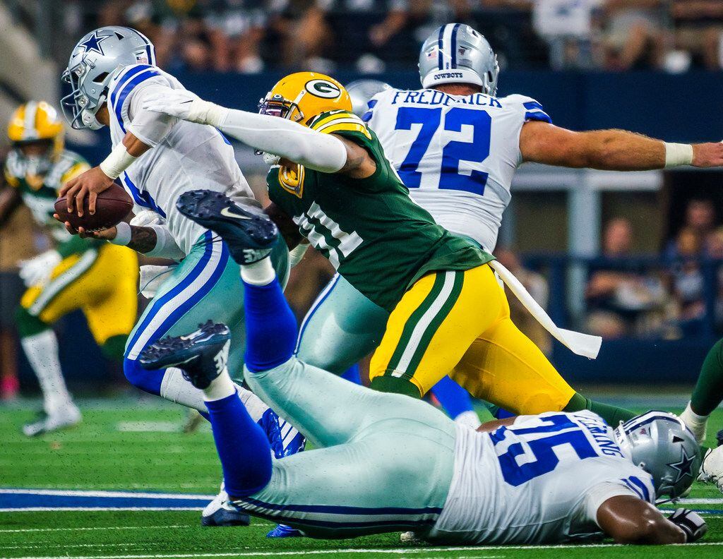 Dallas Cowboys quarterback Dak Prescott (4) is sacked by Green Bay Packers outside...