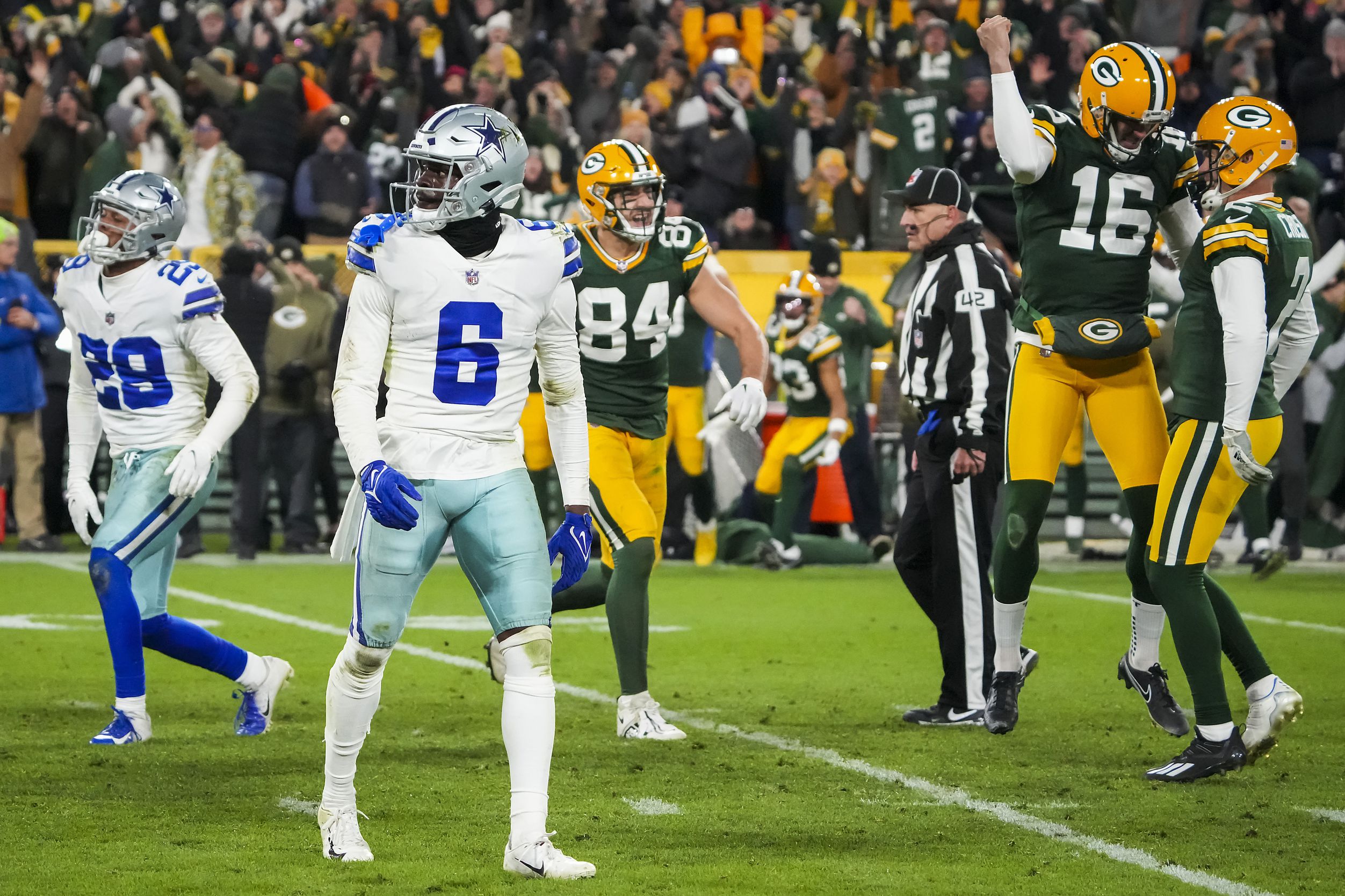 Dallas Cowboys' CeeDee Lamb (88), Dak Prescott (4) and Tony Pollard (20)  celebrate after Lamb scored a touchdown during the first half of an NFL  football game against the Green Bay Packers