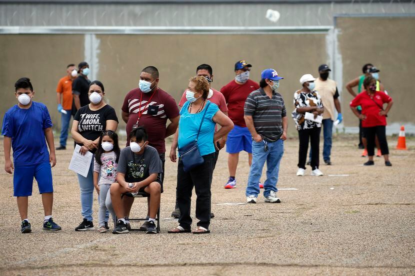 The Contreras family waits in line at a coronavirus free testing site in Dallas, on...
