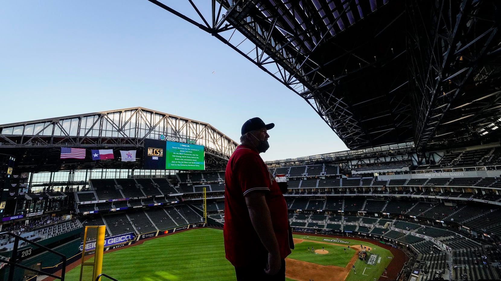 Atlanta Braves fan Michael DeBord, who is originally from Atlanta but now lives in North Texas, watches the retractable roof opening before Game 1 of a National League Championship Series between the Los Angeles Dodgers and the Atlanta Braves at Globe Life Field on Monday, Oct. 12, 2020.