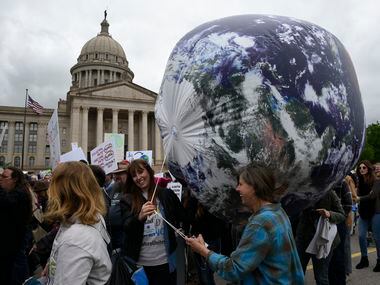 Members of the Oklahoma Nature Conservancy carry an inflatable globe during the March For...