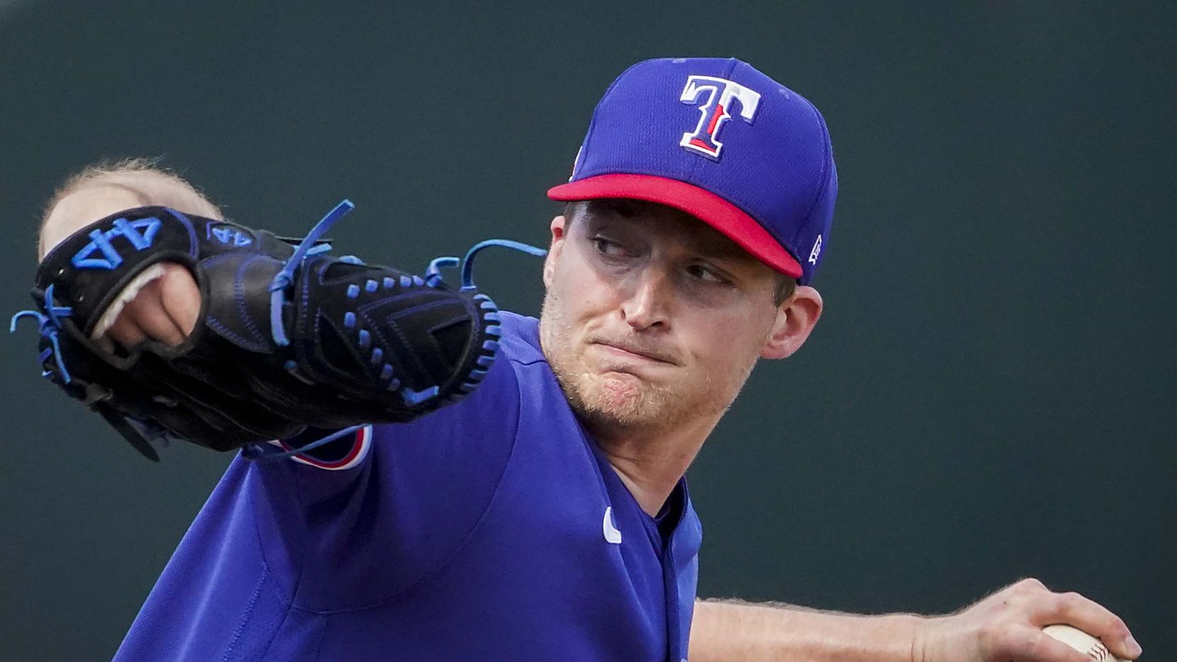 Texas Rangers pitcher Wes Benjamin delivers during the third inning of a spring training...