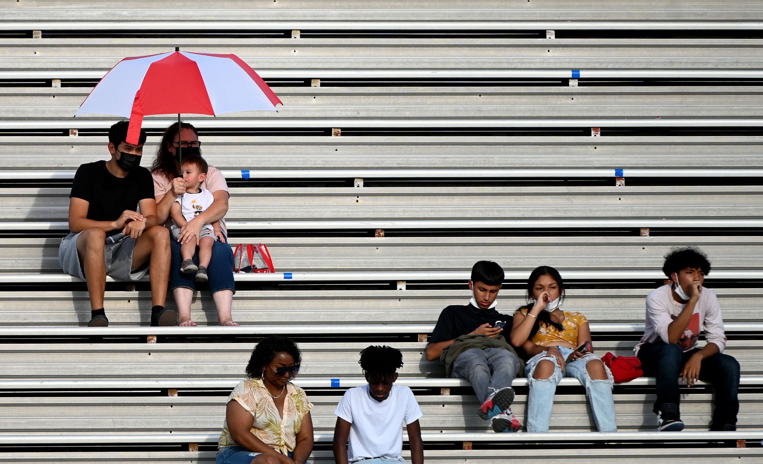 Adamson sit in the stands in the first half during a high school football game between...