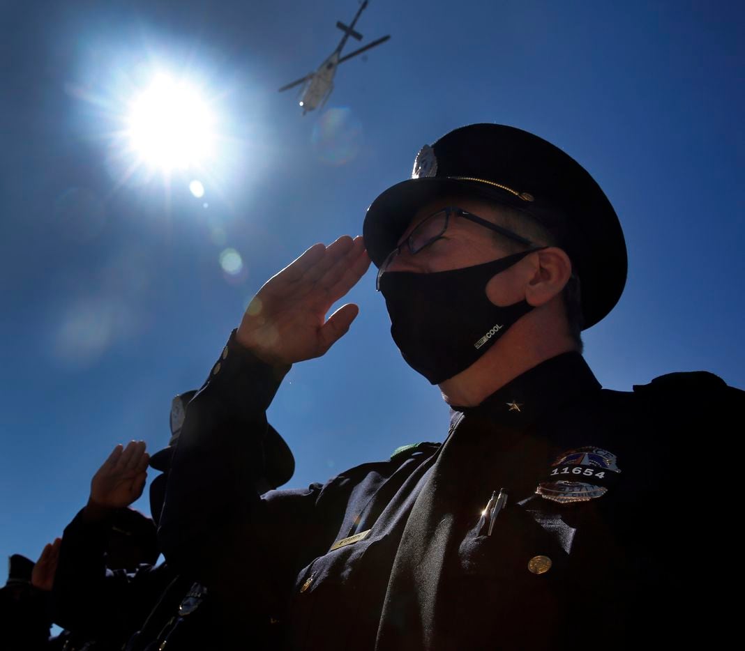 The Dallas Police helicopter makes a fly by over during the funeral service for Dallas Police officer Mitchell Penton at Prestonwood Baptist Church in Plano, Monday, February 22, 2021. Penton was killed Saturday, Feb. 13, 2021, in a crash involving a drunk driving suspect. (Tom Fox/The Dallas Morning News)