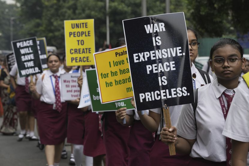 Schoolchildren participate in a peace rally against ethnic clashes in Manipur state, in...
