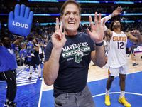 Dallas Mavericks owner Mark Cuban signals there will a Game 7 after his team beat the...