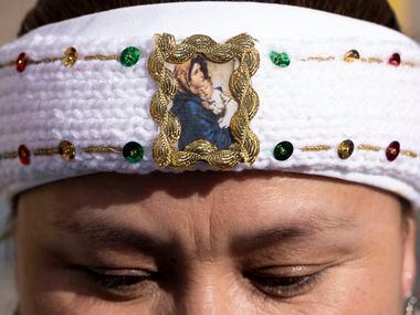 Nancy Sanchez wears a headband with an image of “Madonna and Child” outside the Earle Cabell...