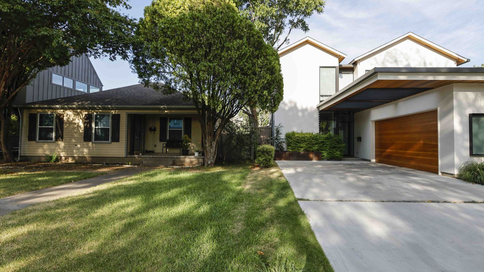 One of Elm Thicket-Northpark's traditional homes sits between two new-design contemporary...