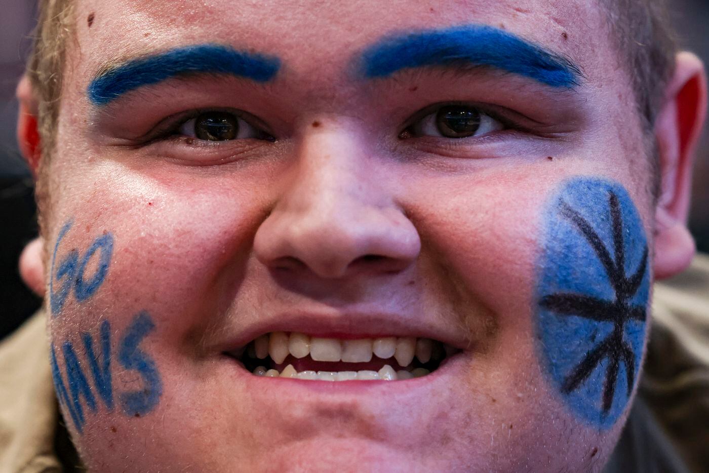 James Barrett smiles for a photo with a painted face supporting the Dallas Mavericks during...