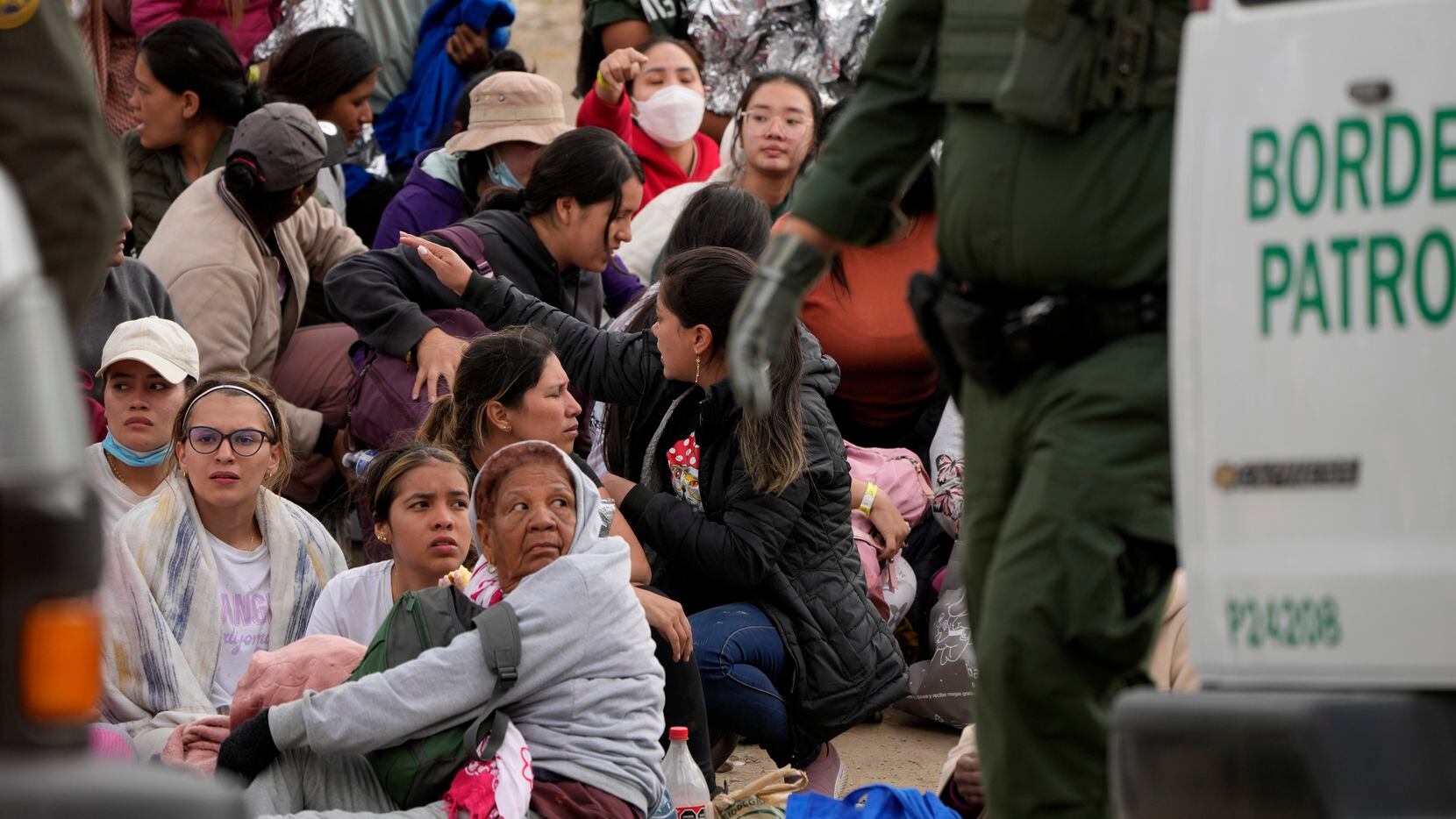 La gente espera para solicitar asilo entre dos muros fronterizos el jueves 11 de mayo de...