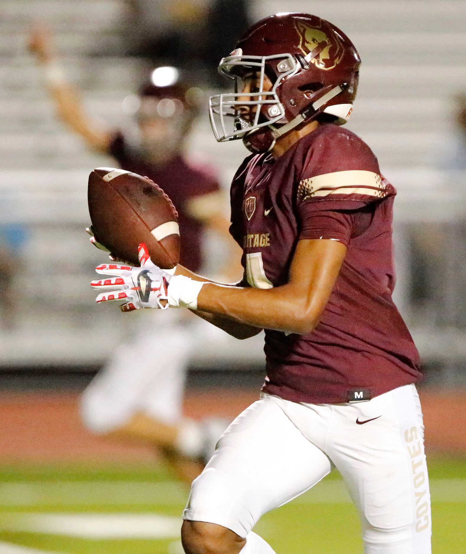 Heritage High School wide receiver Carsten Brewer (4) runs for a touchdown after the catch...