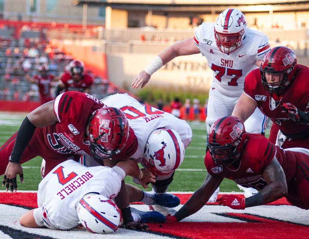 FILE - Arkansas State defensive end William Bradley-King (upper left) sacks SMU quarterback Shane Buechele (7) in the end zone for a safety during the first half of a game on Saturday, Aug. 31, 2019, in Jonesboro, Ark. (The Jonesboro Sun via AP)