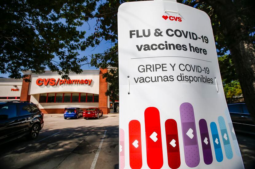 A CVS Pharmacy in the 8000 block of Walnut Hill Lane in Dallas advertises Flu and COVID-19...