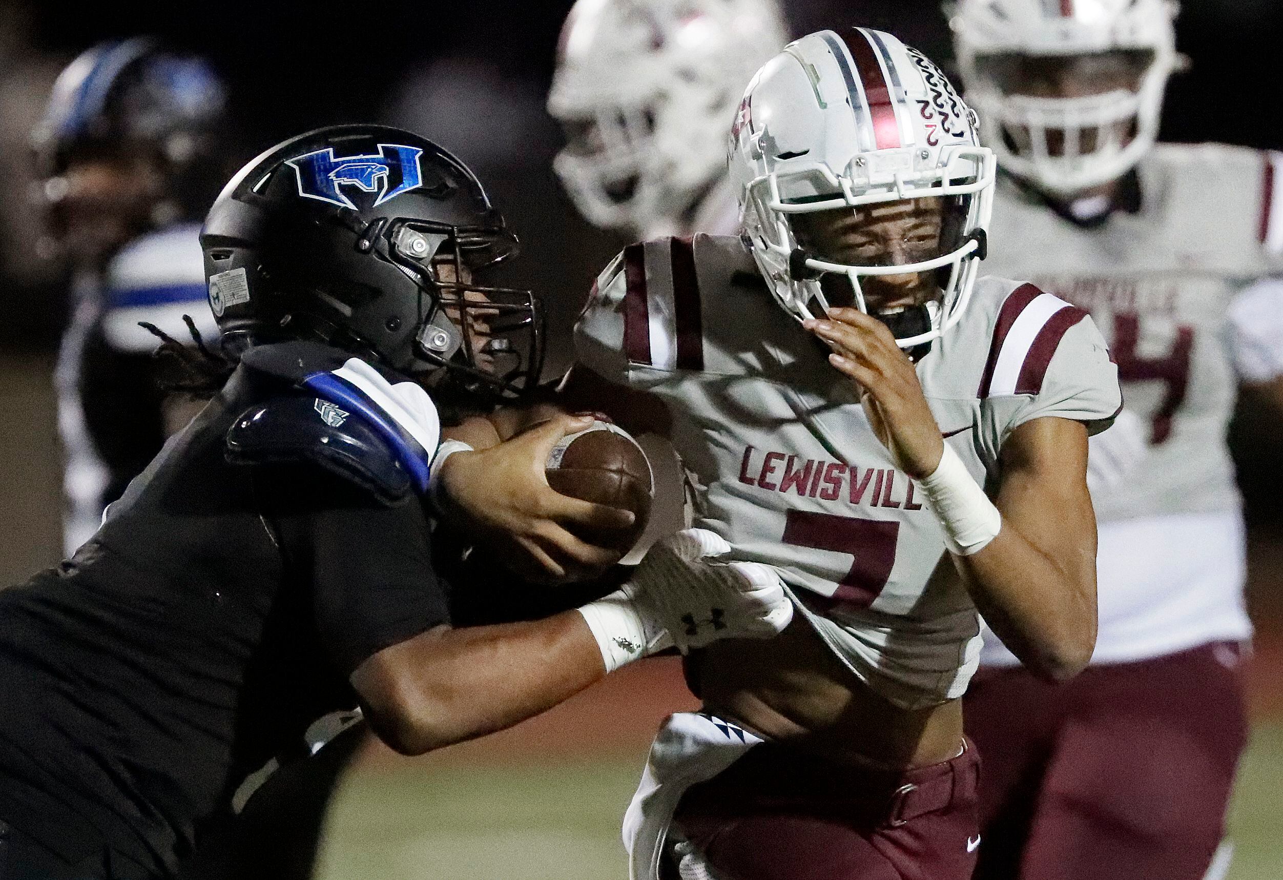 Lewisville High School quarterback Ethan Terrell (7) is caught by Hebron High School...