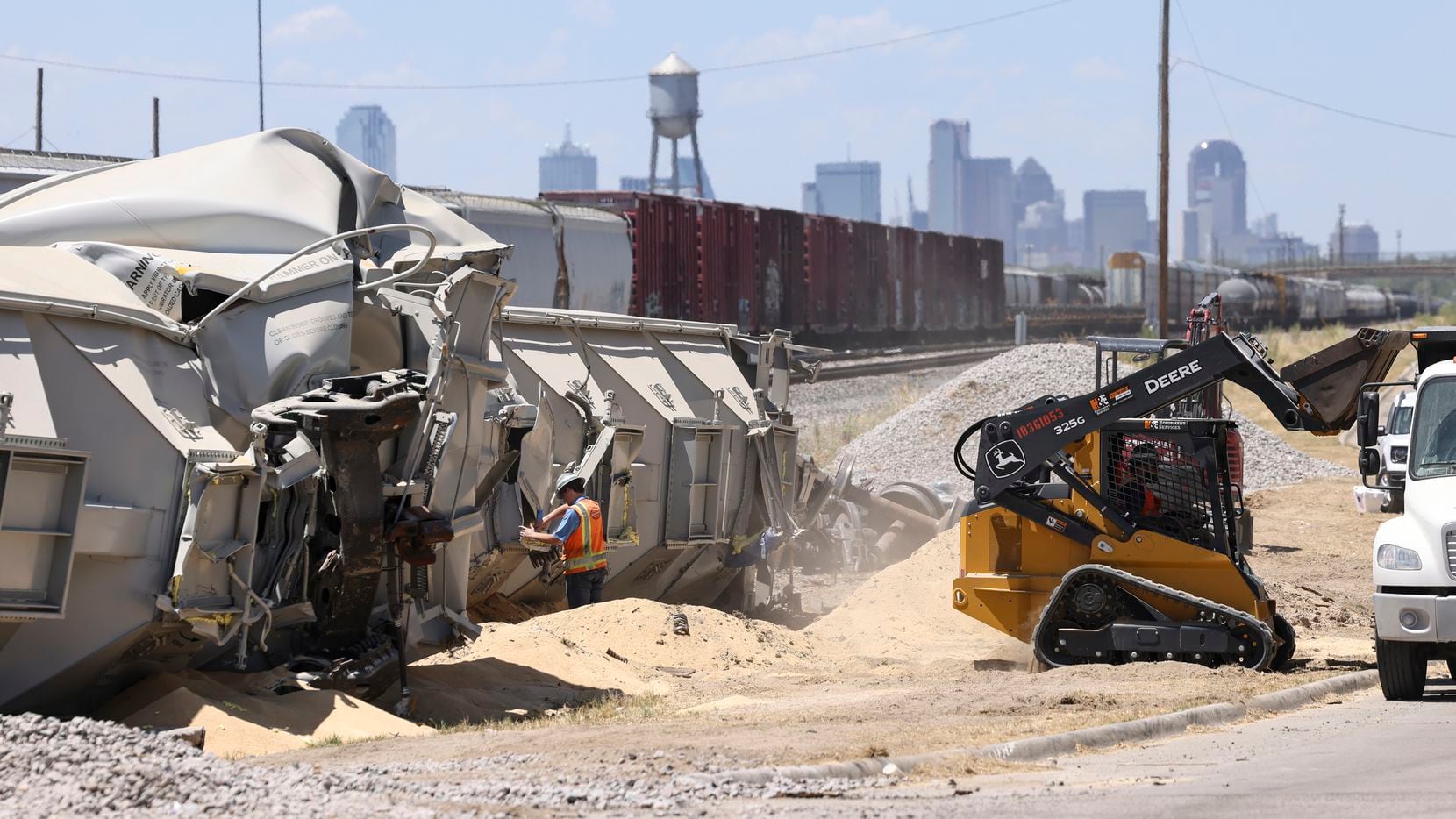 Contract workers from Hulcher move sand and debris during the aftermath clean up from a...