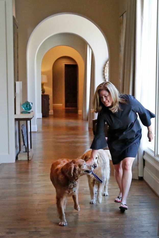 TCU head football coach Gary Patterson's wife Kelsey Patterson walks with the couple's dogs in the hallway of their home in Fort Worth, Texas on Wednesday, July 5, 2018. (Louis DeLuca/The Dallas Morning News)