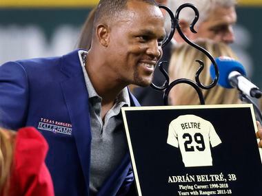 Former Texas Rangers third baseman Adrian Beltre leans in to have a photo made with his...