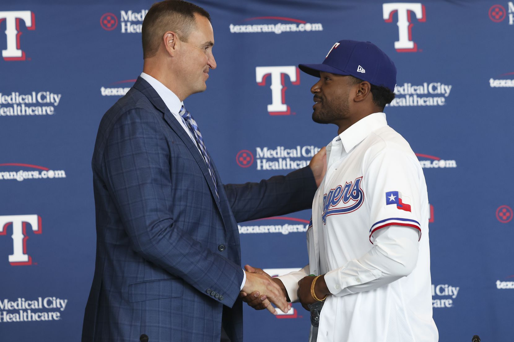 Chris Young, Rangers general manager, shakes hands with Kumar Rocker, first-round draft...