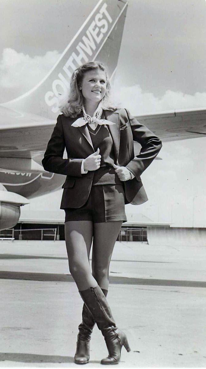 A Southwest Airlines flight attendant models the iconic hot pants uniform that the crews used to wear.