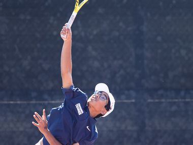 Frisco Centennial’s Akshay Kommineni serves the ball during a mixed doubles match with...