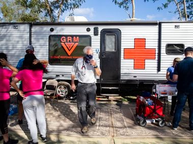 Volunteer doctors and other medical professionals set up outside the Global Response Management trailer to provide health services at the temporary camp in Matamoros, Mexico, on Sunday, Dec. 15, 2019.