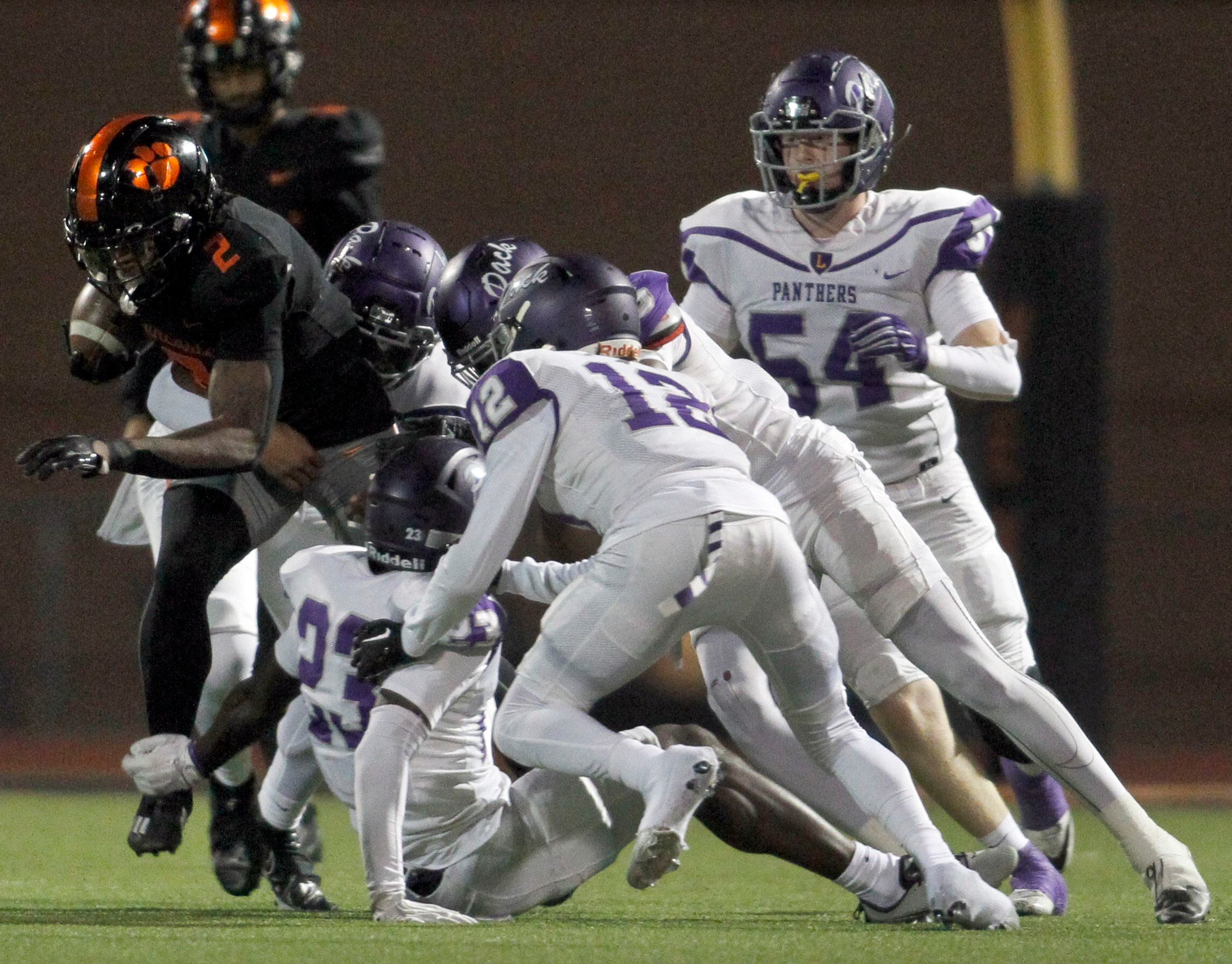 Lancaster running back Kewan Lacy (2), left, draws the attention of the Lufkin defense...