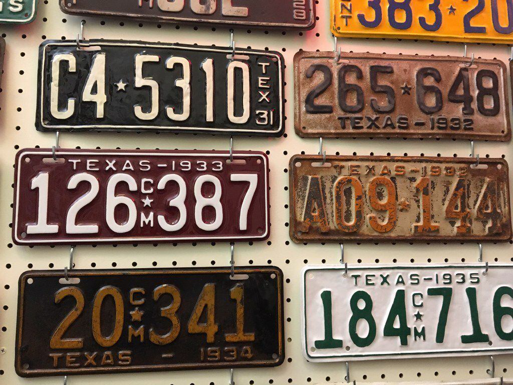 Former state Rep. Joe Pickett, D-El Paso, had nearly 160 vintage Texas license plates on the walls of his Capitol office in 2017. In the middle row are two plates from 1933, with burnt orange against a white background on right, commemorating the University of Texas, and white on maroon at left, honoring Texas A&M University.