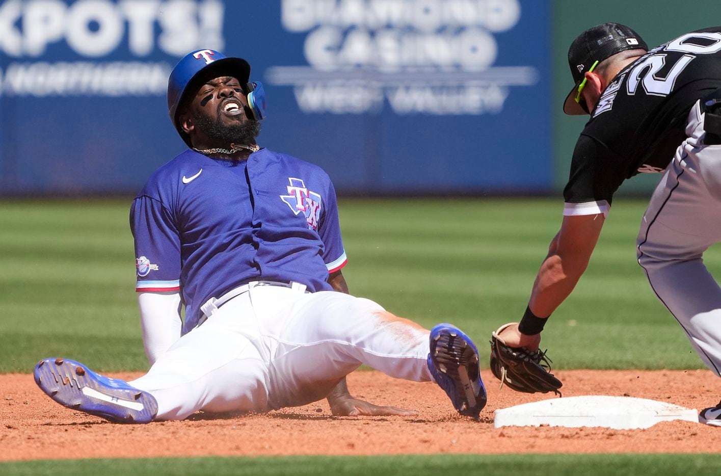 Texas Rangers outfielder Adolis García is out at second base after sliding past the bag on a...