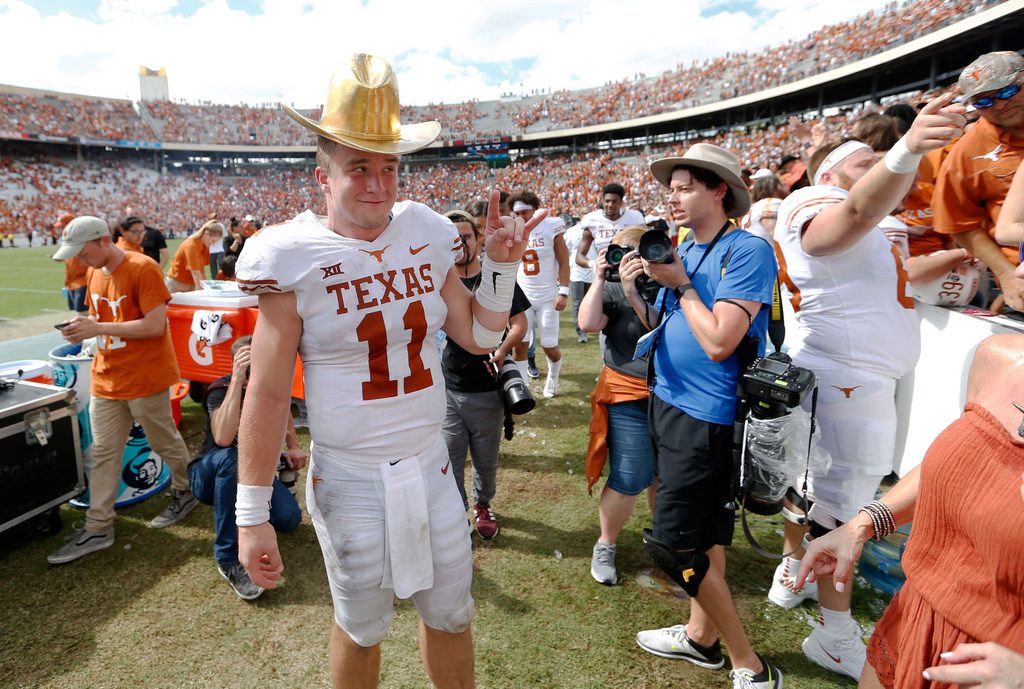 Texas quarterback Sam Ehlinger (11) wears the golden hat as he poses for photos for his...