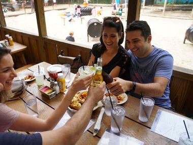 Peyman & Maryam Etebari and their friends Parya & Masoud Saman enjoy food and drinks while...