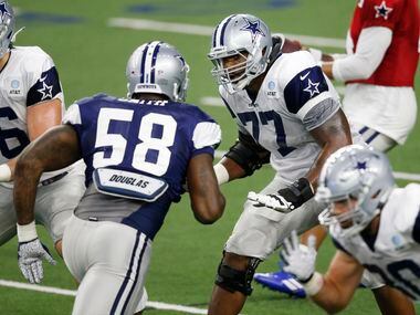 Dallas Cowboys offensive tackle Tyron Smith (77) looks to block Dallas Cowboys defensive end Aldon Smith (58) during training camp inside the Ford Center at the Dallas Cowboys headquarters at The Star in Frisco, Texas on Tuesday, August 18, 2020.