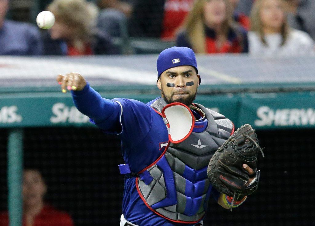 Texas Rangers catcher Robinson Chirinos throws out Cleveland Indians' Lonnie Chisenhall at...
