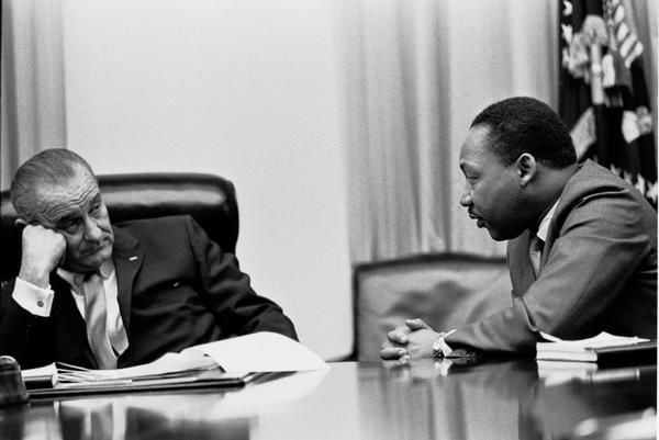 
President Lyndon B Johnson discusses the Voting Rights Act with civil rights campaigner Martin Luther King Jr. 
