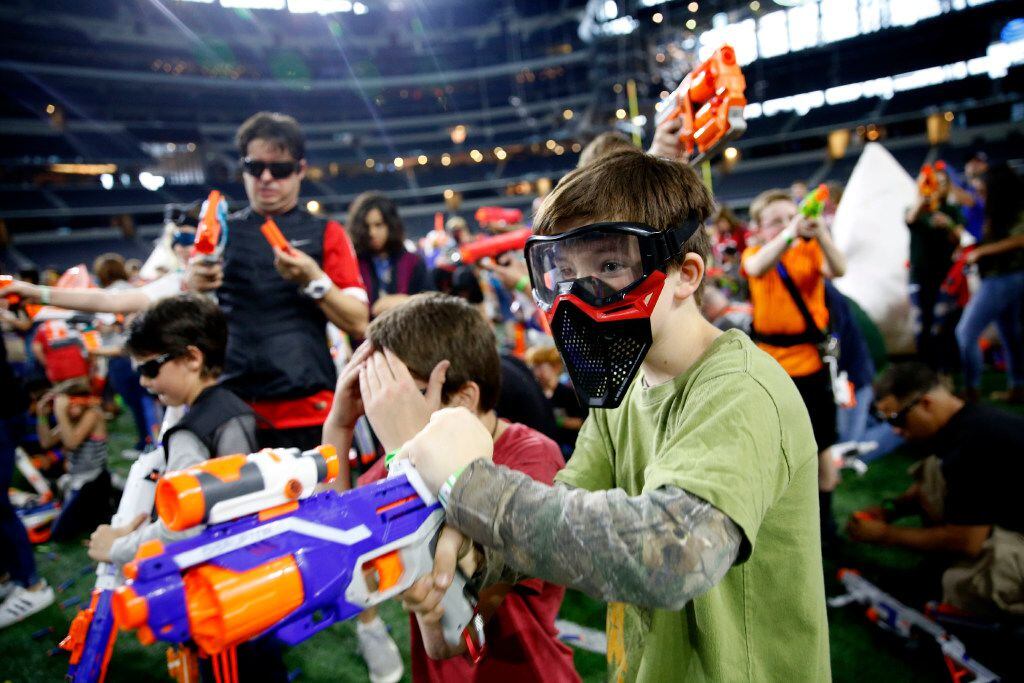 Jered Liske, 10, fires a Nerf gun during Jared's Epic Nerf Battle 2 at AT&T Stadium in...