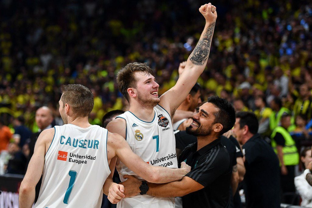 TOPSHOT - Real Madrid's Slovenian Luka Doncic (R) celebrates with team mate Real Madrid's...