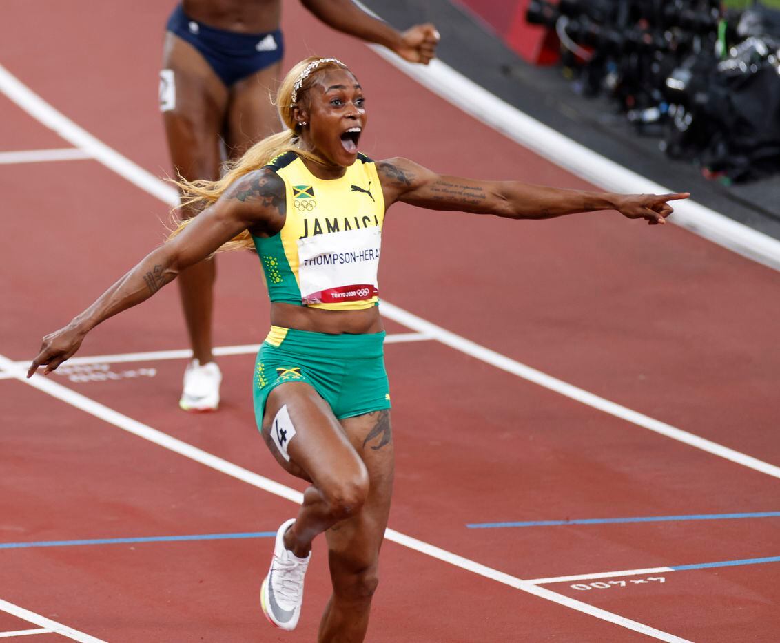 Jamaica’s Elaine Thompson-Herah celebrates as she comes across the finish line winning the...