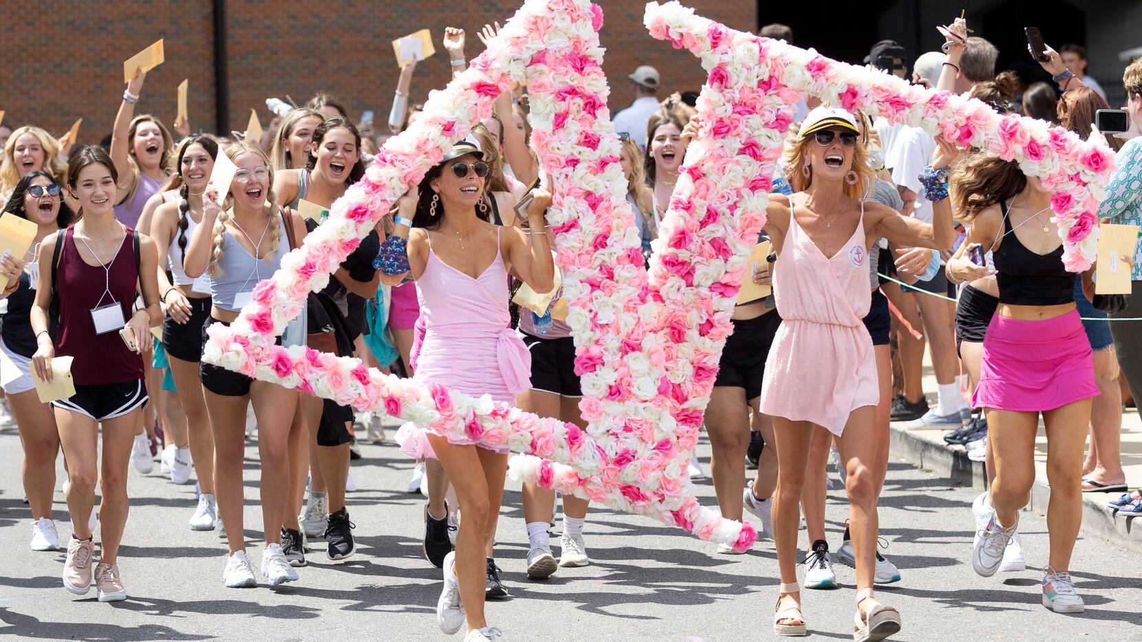 A group of newly picked Delta Gamma sorority pledgees run out of Bryant-Denny Stadium to...