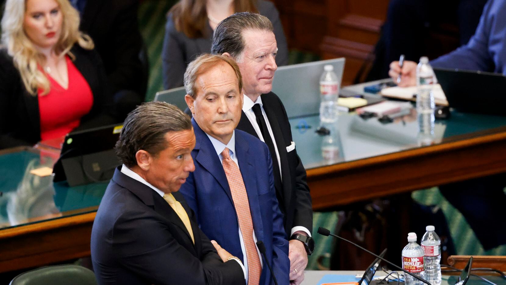 Texas Attorney General Ken Paxton (center) stands with his lawyers Tony Buzbee (left) and...