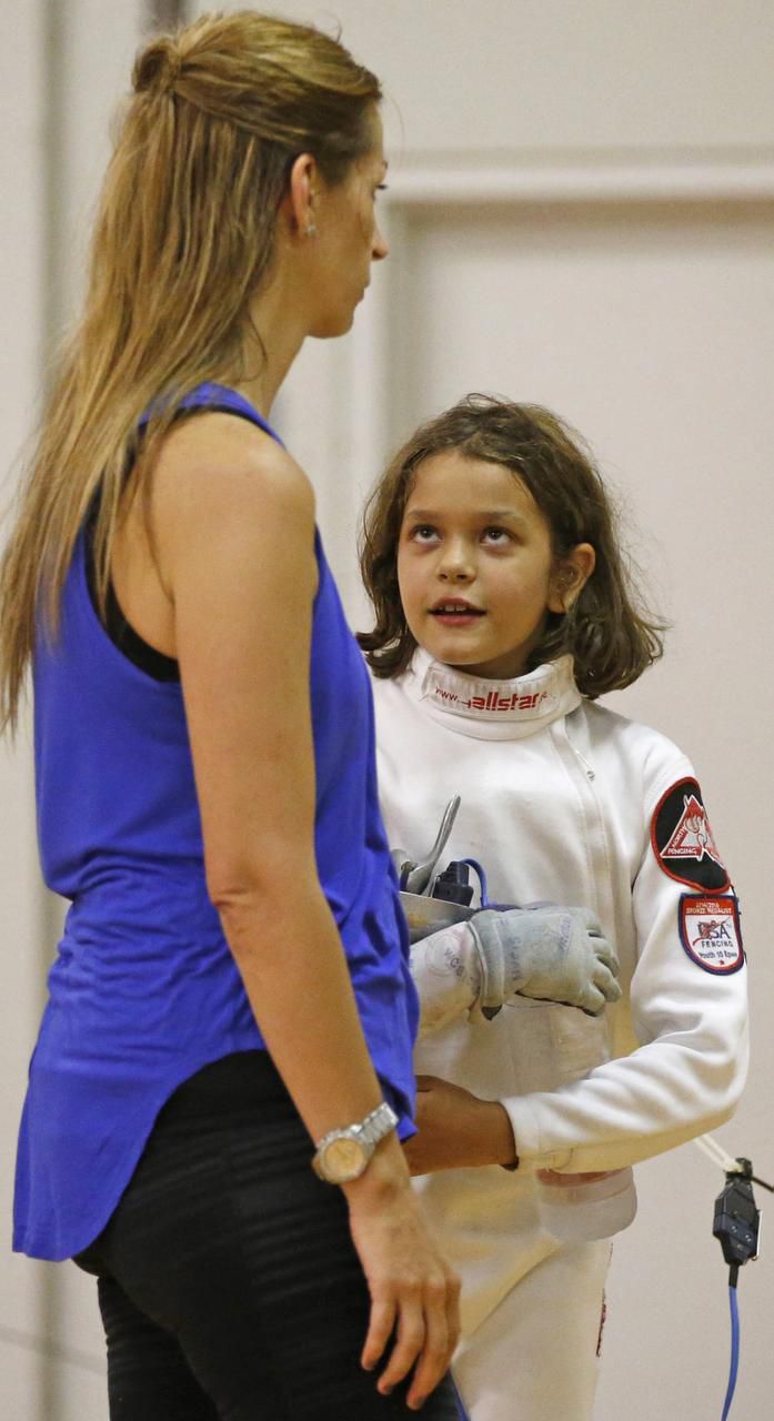 
Yasmine Khamis, 9, talks to her mother and coach, Michele Khamis, during practice at North...