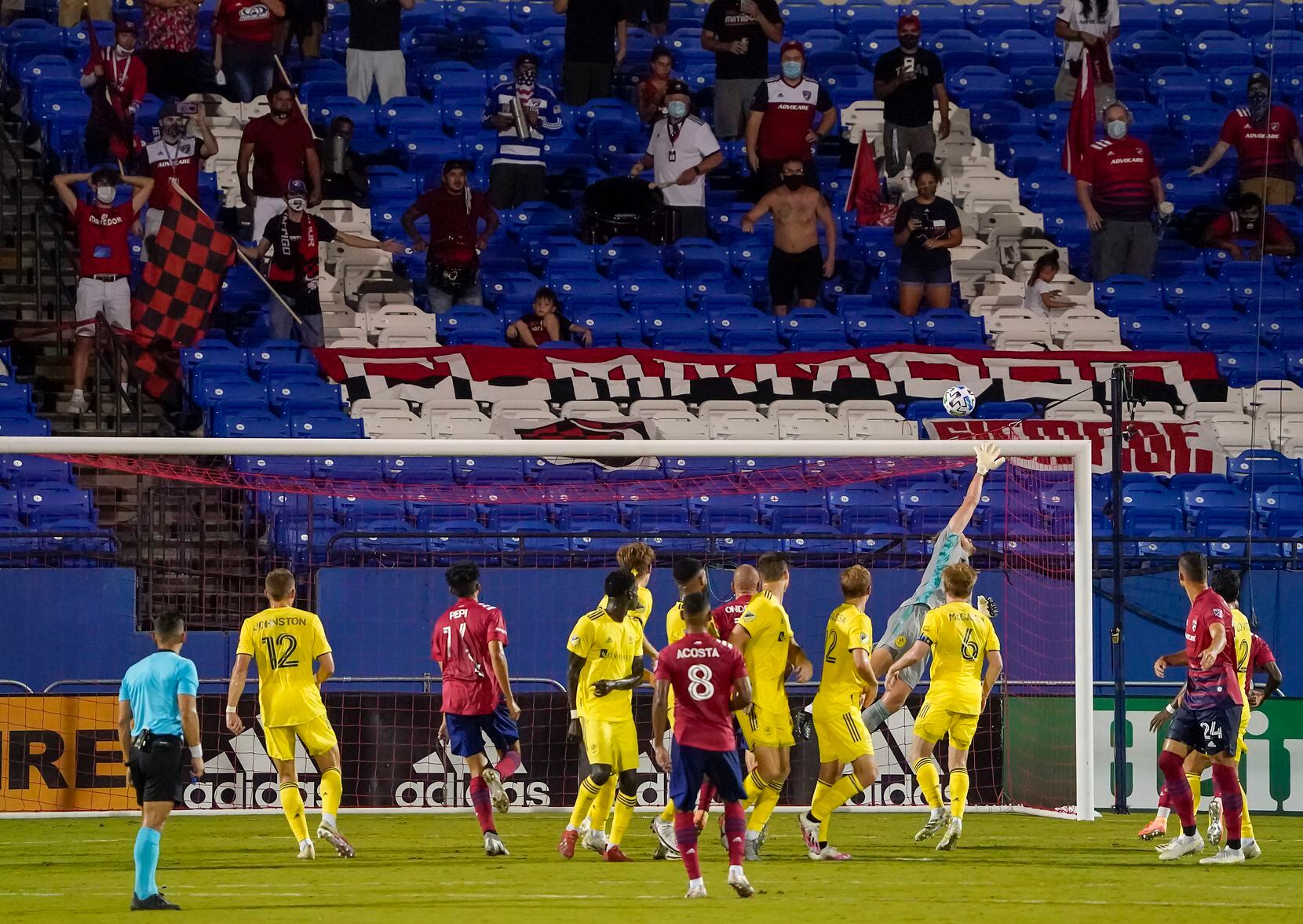 Socially distant FC Dallas supporters watch as a free kick by FC Dallas midfielder Bryan Acosta (8) sails over the bar, and Nashville SC goalkeeper Joe Willis, on the final play in added time of an MLS soccer game at Toyota Stadium on Wednesday, Aug. 12, 2020, in Frisco, Texas. Nashville SC won the game 1-0. (Smiley N. Pool/The Dallas Morning News)
