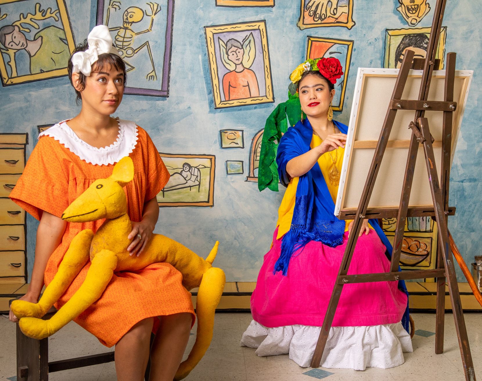 Mariana (soprano Robin Steitz) sits for a portrait with the great Mexican artist Frida Kahlo (mezzo-soprano Kayla Nanto) in the Fort Worth Opera's "Frida Kahlo and the Bravest Girl in the World," which is streaming online for students.