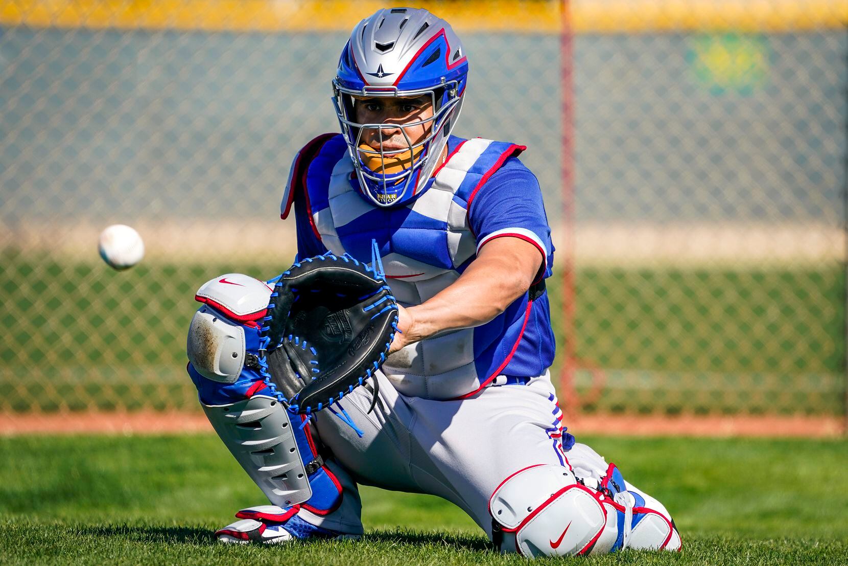Texas Rangers catcher Robinson Chirinos  participates in a drill during a spring training...