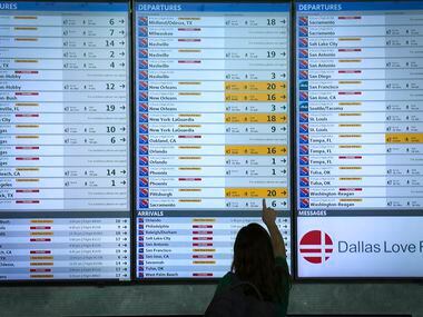 Flight status boards show Southwest flights either cancelled or delayed up and down the...