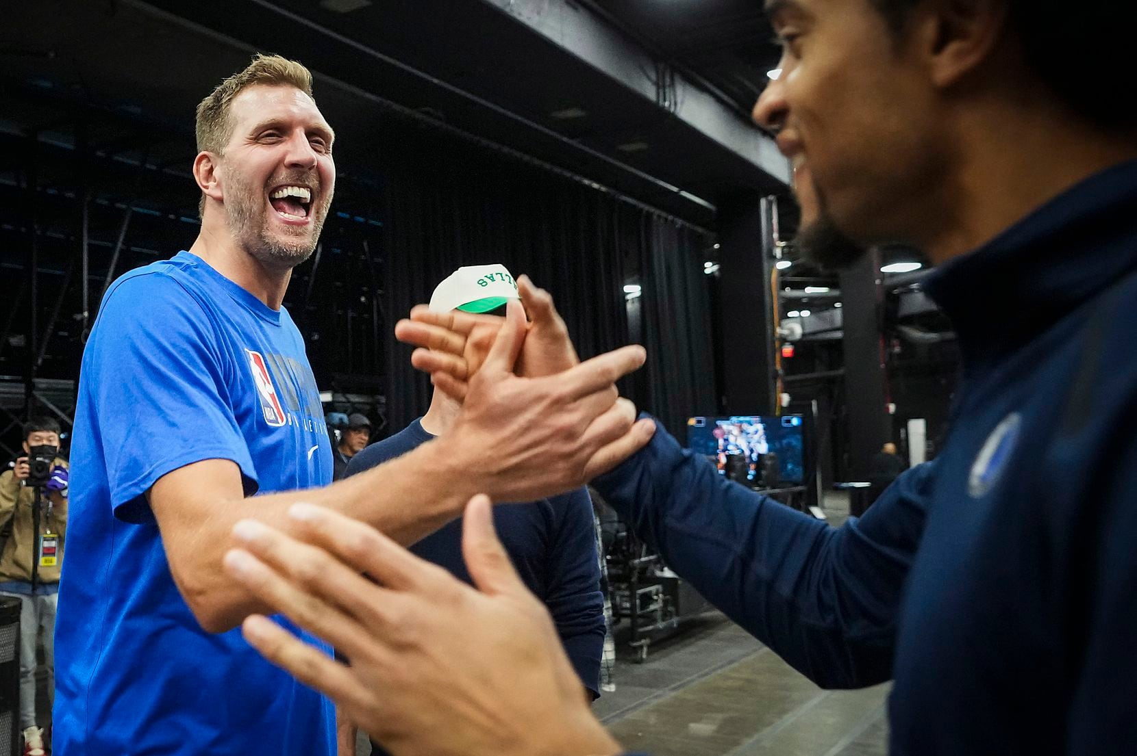 Dallas Mavericks great Dirk Nowitzki celebrates with team staff after a victory over the...