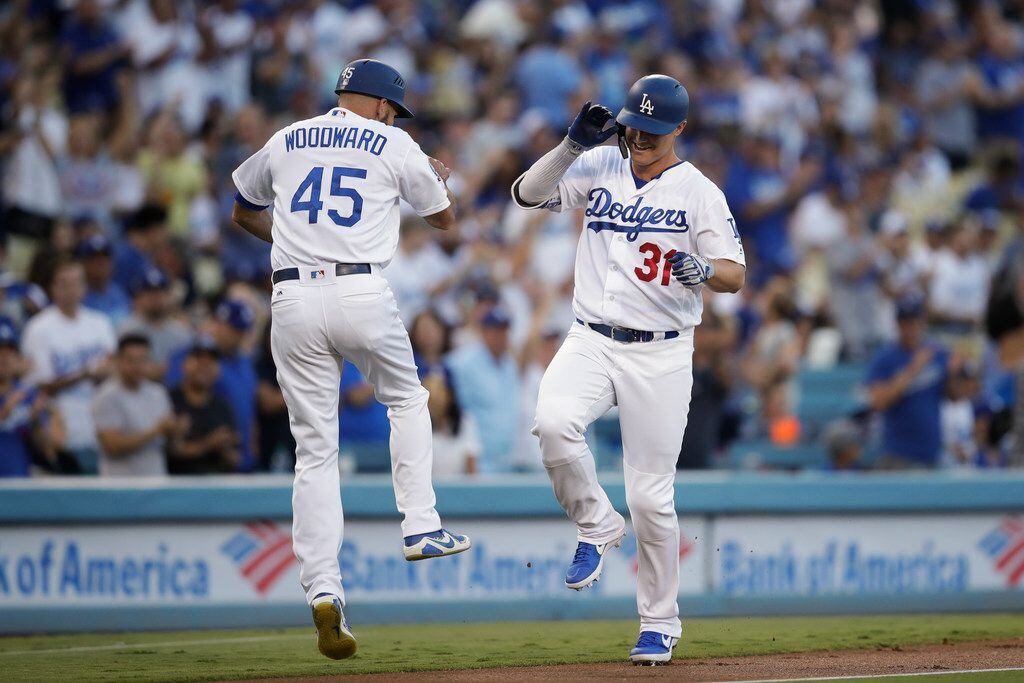 Los Angeles Dodgers' Joc Pederson, right, celebrates his home run with third base coach...