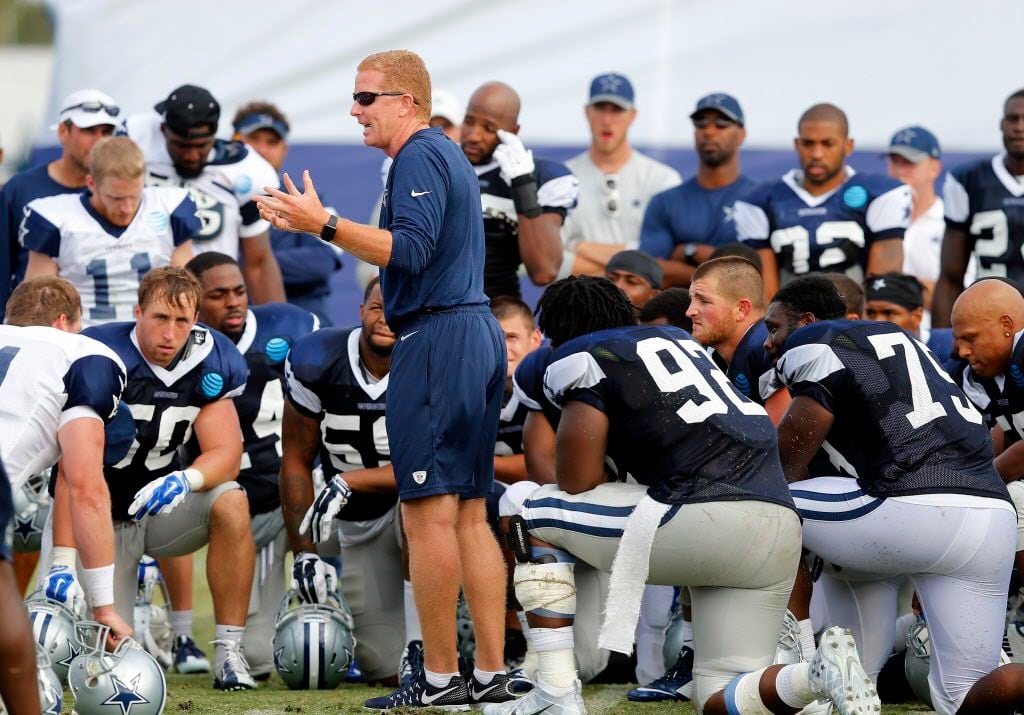 Dallas Cowboys head coach Jason Garrett visits with his team following afternoon practice at...