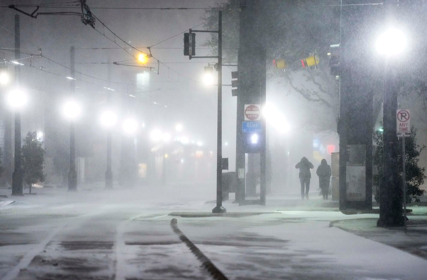 Blowing snow obscures people walking along Bryan Streen near the Pearl/Arts District station as a winter storm brings snow and freezing temperatures to North Texas on Sunday, Feb. 14, 2021, in Dallas.