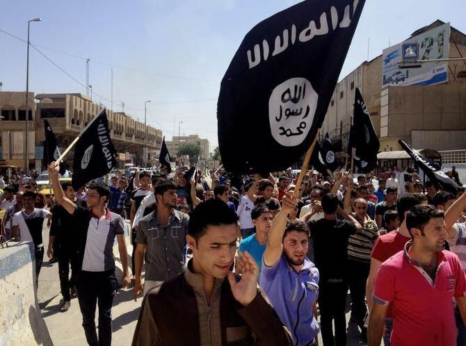 
Demonstrators in Mosul, Iraq, carry al-Qaeda flags and chant slogans to support the Islamic...
